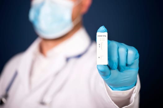Doctor holding a test kit for viral disease COVID-19. Lab card kit tested NEGATIVE for viral novel coronavirus sars-cov-2 virus.