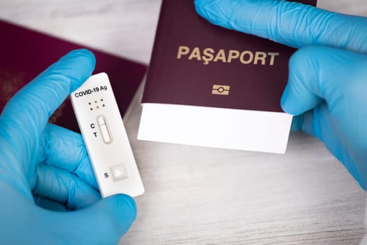 Doctor holding passport and negative covid-19 ( rapid antigen SARS-CoV-2 Ag ) test. Coronavirus and safety travel concept.