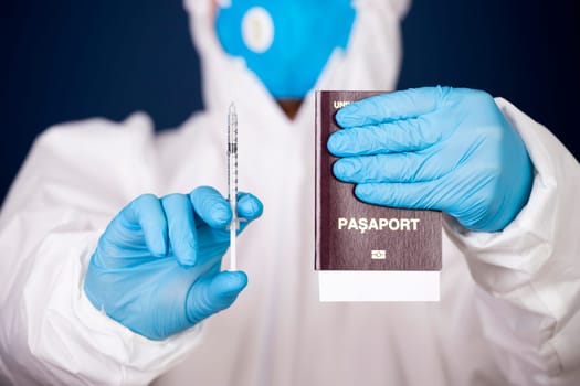 Doctor holding passport and vaccine. Immunity passport, risk-free certificate concept.