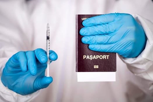 Doctor holding passport and vaccine. Immunity passport, risk-free certificate concept.