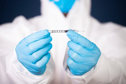 Concept of herd immunity, virus spreading in society. Doctor with syringe is preparing for vaccine.