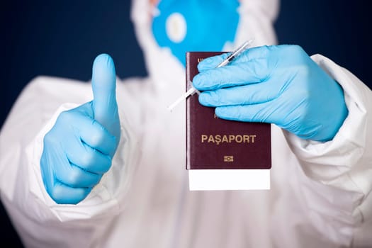 Doctor holding passport and vaccine. Immunity passport, risk-free certificate concept.