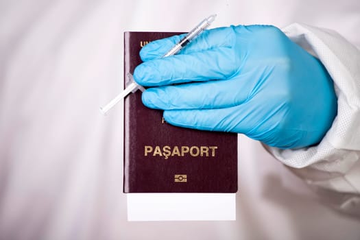 Doctor holding passport and vaccine. Immunity passport, risk-free certificate concept.