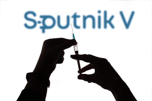 Cluj-Napoca, Romania - March 15, 2021:  New coronavirus vaccine Sputnik V concept, blurred Sputnik V logo on the background. Covid-19, 2019-nCov pandemic.
