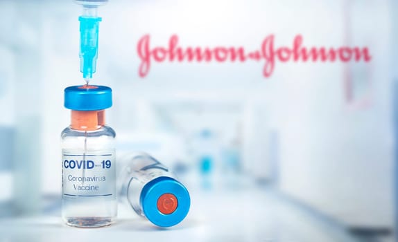 Cluj-Napoca, Romania - March 15, 2021:  New coronavirus vaccine Johnson and Johnson  concept, blurred Johnson and Johnson logo on the background. Covid-19, 2019-nCov pandemic.