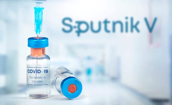 Cluj-Napoca, Romania - March 15, 2021:  New coronavirus vaccine Sputnik V concept, blurred Sputnik V logo on the background. Covid-19, 2019-nCov pandemic.
