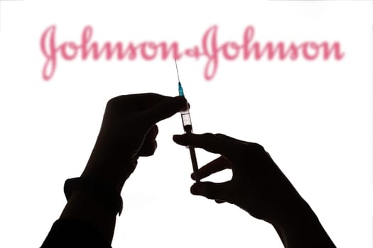 Cluj-Napoca, Romania - March 15, 2021:  New coronavirus vaccine Johnson and Johnson  concept, blurred Johnson and Johnson logo on the background. Covid-19, 2019-nCov pandemic.