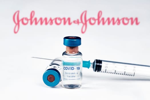 Cluj-Napoca, Romania - March 15, 2021:  New coronavirus vaccine Johnson and Johnson  concept, blurred Johnson and Johnson logo on the background. Covid-19, 2019-nCov pandemic.