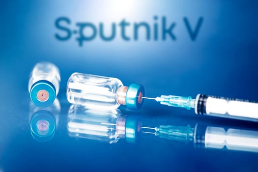 Cluj-Napoca, Romania - March 15, 2021:  New coronavirus vaccine Sputnik V concept, blurred Sputnik V logo on the background. Covid-19, 2019-nCov pandemic.