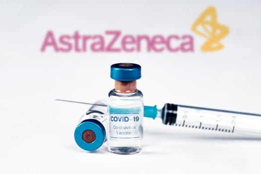 Cluj-Napoca, Romania - March 15, 2021:  New coronavirus vaccine Astra Zeneca concept, blurred Astra Zeneca logo on the background. Covid-19, 2019-nCov pandemic.
