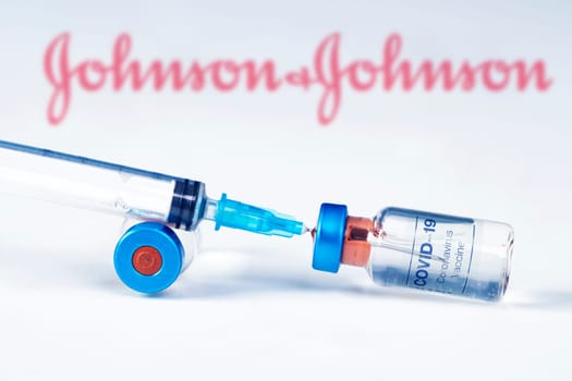Cluj-Napoca, Romania - March 15, 2021:  New coronavirus vaccine Johnson and Johnson  concept, blurred Johnson and Johnson logo on the background. Covid-19, 2019-nCov pandemic.