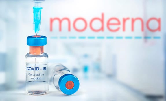 Cluj-Napoca, Romania - March 15, 2021:  New coronavirus vaccine Moderna concept, blurred Moderna logo on the background. Covid-19, 2019-nCov pandemic.