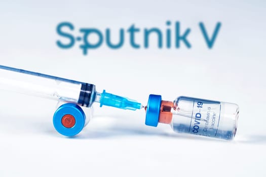 Cluj-Napoca, Romania - March 15, 2021:  New coronavirus vaccine Sputnik V concept, blurred Sputnik V logo on the background. Covid-19, 2019-nCov pandemic.