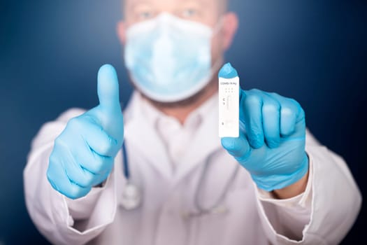 Doctor holding a test kit for viral disease COVID-19. Lab card kit tested NEGATIVE for viral novel coronavirus sars-cov-2 virus.