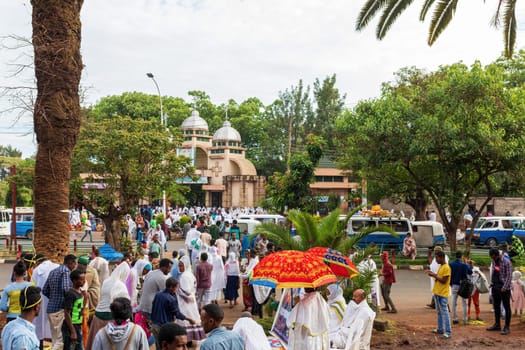 Azezo, Amhara Region, Ethiopia - April 21, 2019: Orthodox Christian people white dressed walk to mass on the street during easter holiday. Bahir Dar, Ethiopia