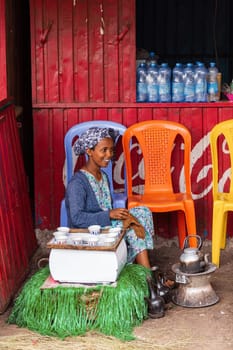 Adis Zemen, Ethiopia - April 22, 2019: Ethiopian traditional Coffee maker, local women preparing bunna cafe in city Adis Zemen, Ethiopia, Africa