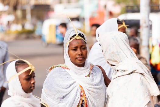 Azezo, Amhara Region, Ethiopia - April 21, 2019: Orthodox Christian woman white dressed walk to mass on the street during easter holiday. Bahir Dar, Ethiopia