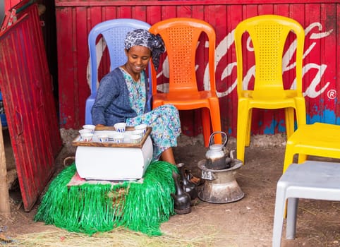 Adis Zemen, Ethiopia - April 22, 2019: Ethiopian traditional Coffee maker, local women preparing bunna cafe in city Adis Zemen, Ethiopia, Africa