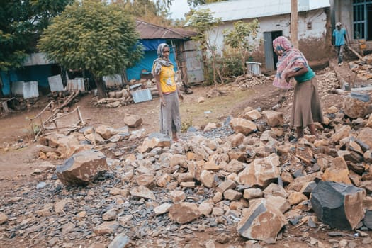 Azezo, Amhara Region, Ethiopia - April 22, 2019: Ethiopian women prepare stones to build a house, hard work of women in Africa, Azezo, Ethiopia, Africa