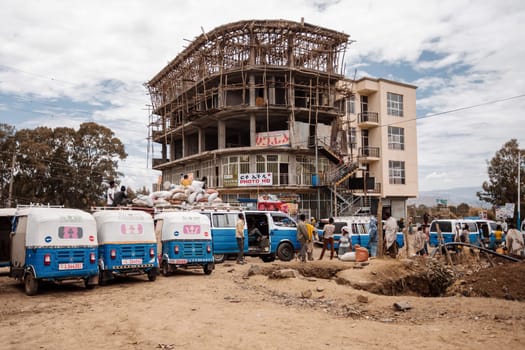 Azezo, Amhara Region, Ethiopia - April 22, 2019: Traditional means of transport in Ethiopia, blue color auto rickshaw known as Tuk tuk on street in city Azezo, Ethiopia, Africa