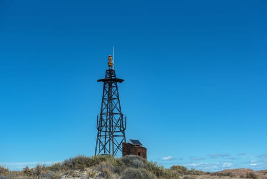 small lighthouse, beacon on the beach of Bahia Bustamante, Argentina