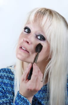 Woman applying makeup
