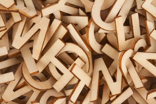 top view closeup detail macro of pile of wooden cut small alphabet letters
