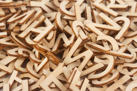 top view closeup detail macro of pile of wooden cut small alphabet letters