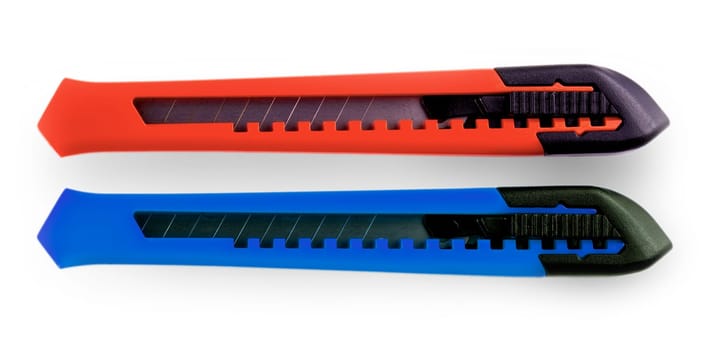 The blue and red paper cutters with closed blade, isolated on white background