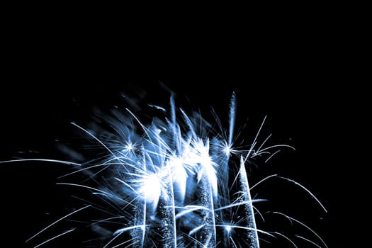 Premium entertainment magic star firework at e.g. New Years Eve or Independence Day party celebration. Black dark night background.