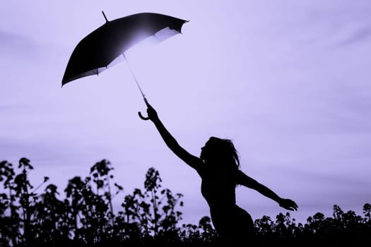 Nature girl at windy rainy day has adventure wanderlust. Wonderful scene of imagination power and departure to new horizons in youth.