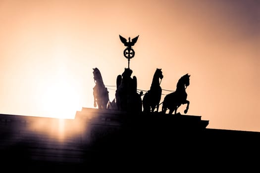 Sunset behind the german capital symbol and european landmark Brandenburger Tor at paris square in sightseeing tourism history tour.
