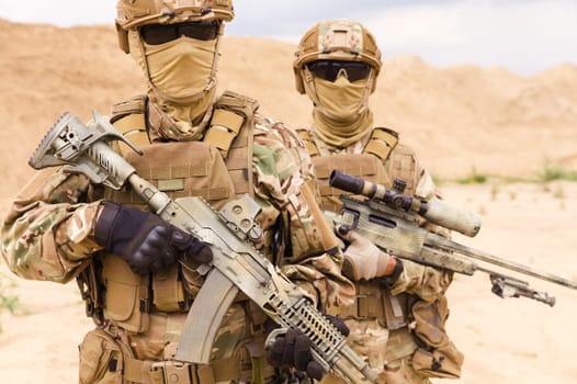 Close-up portrait of equipped and armed special forces soldiers with sniper rifles