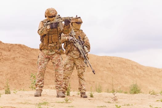 Two special forces snipers in the desert. Concept of military anti-terrorism operations, special operations of NATO forces.