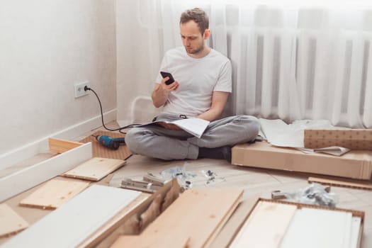 Man looking contacts of help center. Troubles with assembling new furniture, calling for a master