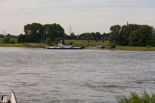 ORSOY, NRW, GERMANY - JUNE 23, 2019:  Ferry City Orsoy on the Rhine. The ferry connects Orsoy in NRW, the city of Duisburg Walsum. Some passengers on the ship