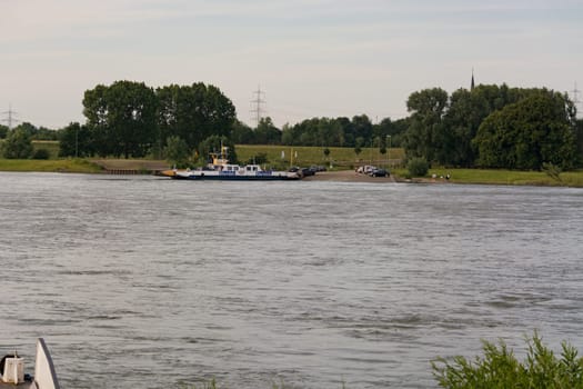 ORSOY, NRW, GERMANY - JUNE 23, 2019:  Ferry City Orsoy on the Rhine. The ferry connects Orsoy in NRW, the city of Duisburg Walsum. Some passengers on the ship
