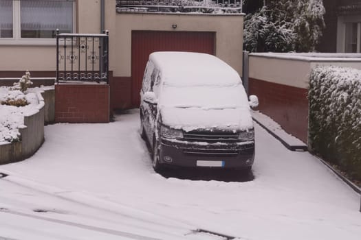 The car in the snow, covered with a white drift of snow.