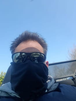 Shot of a serious looking man wearing a mask and sunglasses on infectious diseases.