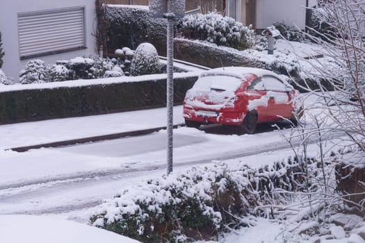 The car in the snow, covered with a white drift of snow.