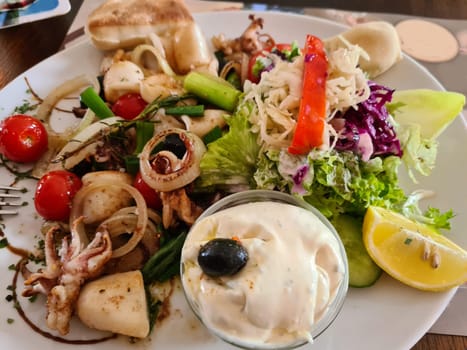 Grilled squid, street food. stuffed squid. salat.