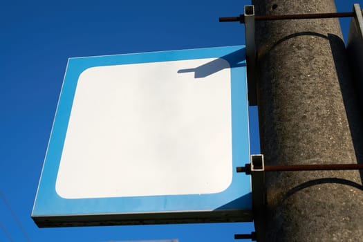 blank white sign with text space copy space without inscription on a pillar at the station