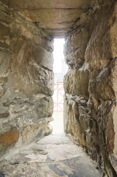 Basement window of an old half-timbered house. The small opening is secured with two bars