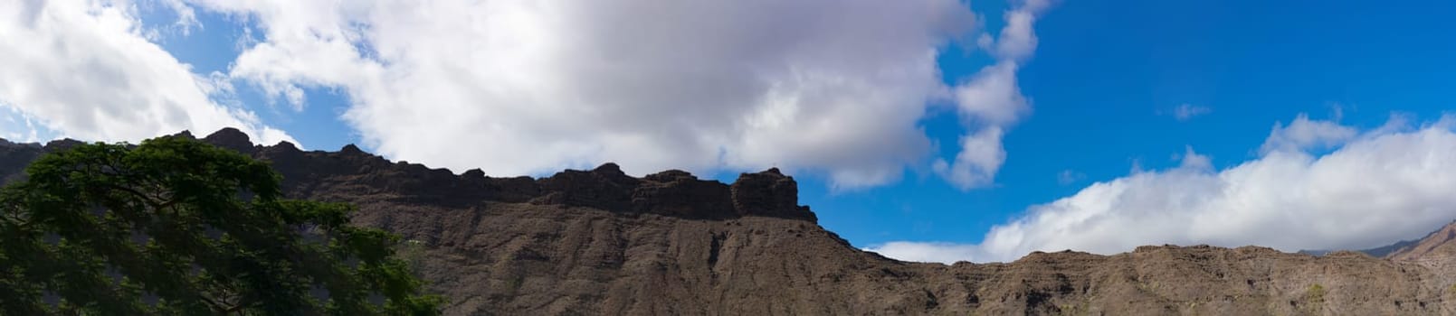 Mountains on the coast between Puerto de Mogan and Puerto Rico. Layers of volcanic rock.