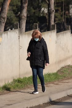 Iasi - Romania - 13th March 2021: Women walking on the sidewalk during a sunny day