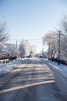 Small streets and trees in town covered in snow