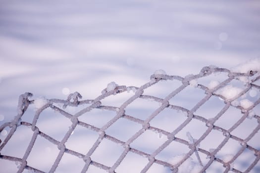 Steel fence covered in snow during winter