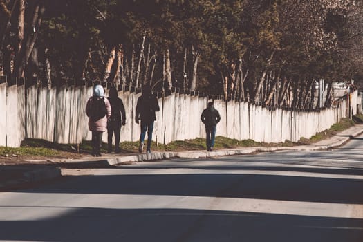 People walking on the sidewalk during a sunny day