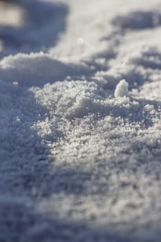 Close up of snow particles and flakes. Winter snow background
