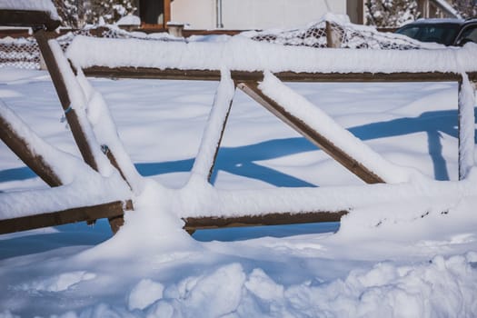 Wood fence covered in snow during winter